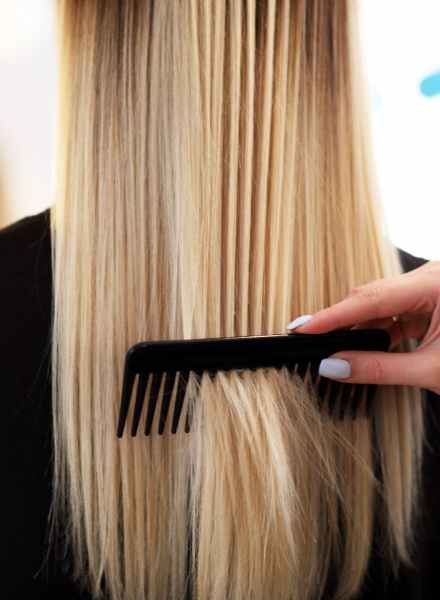 showing a long blonde hair combed after olaplex treatment